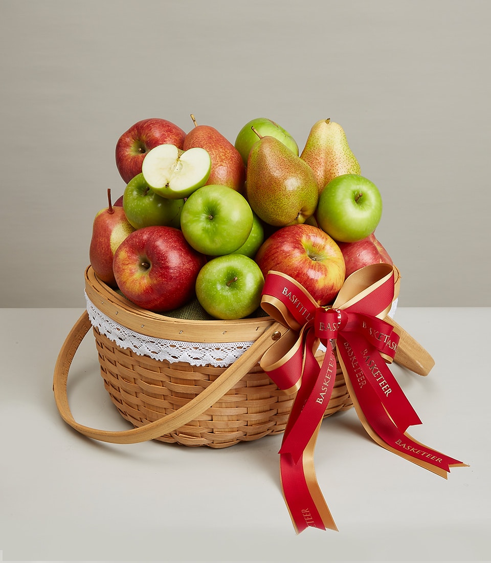 Deluxe wicker fruit hamper with fresh red and green apples, pears, white lace trim and red ribbon bow