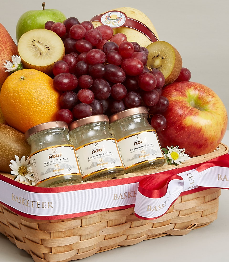 Premium fruit and bird's nest gift basket with fresh grapes, apples, and kiwis in woven wood with gold ribbon