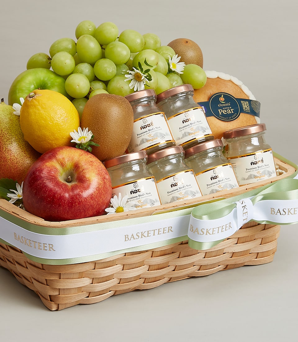 Woven fruit basket with premium bird's nest, fresh grapes, apples, and pear in light brown with gold-trimmed ribbon