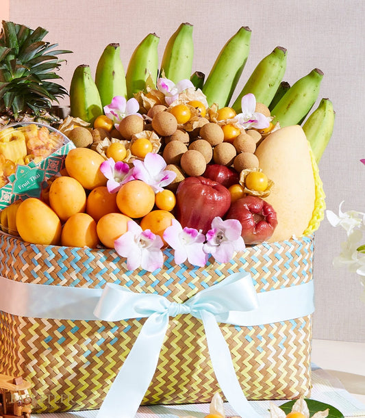 Premium woven fruit basket with Thai tropical fruits, longans, mangoes, rose apples, and fresh orchids, tied with blue satin