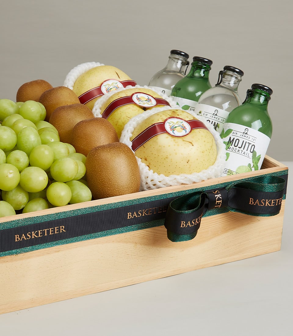 Premium wooden gift box with fresh grapes, kiwis, Asian pears, and artisan bottled beverages