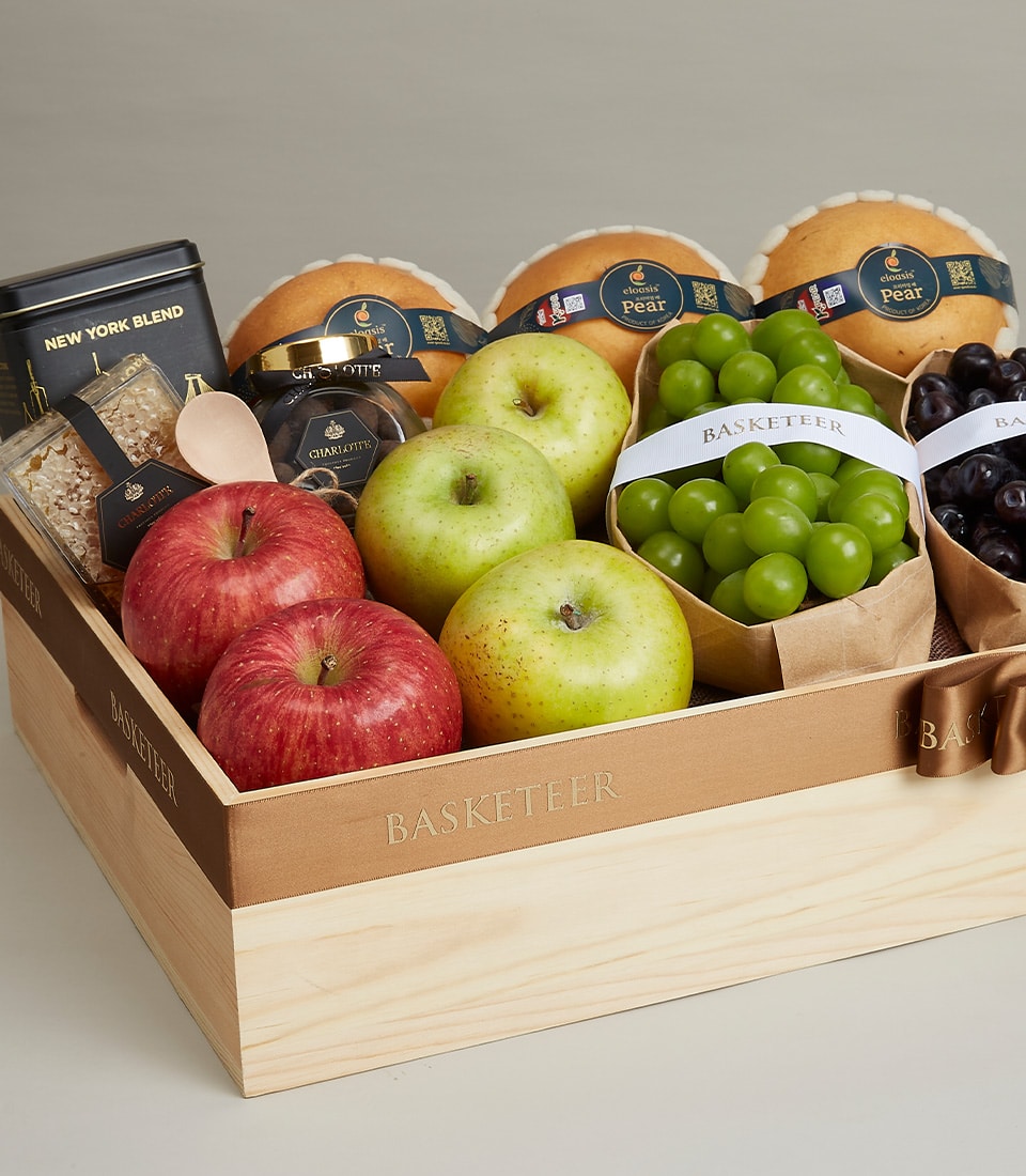 Deluxe wooden gift basket with fresh pears, apples, grapes, gourmet tea, honey, and artisan spreads