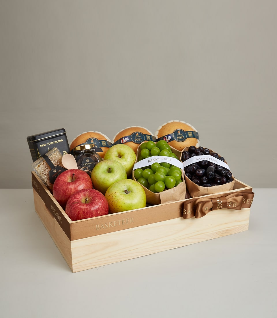 Deluxe wooden gift box with assorted fresh pears, apples, grapes, and gourmet treats with gold ribbon