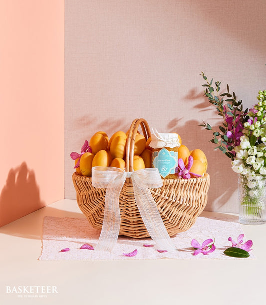 Sweet Marian plum jam gift basket with tropical fruits and white orchid flowers