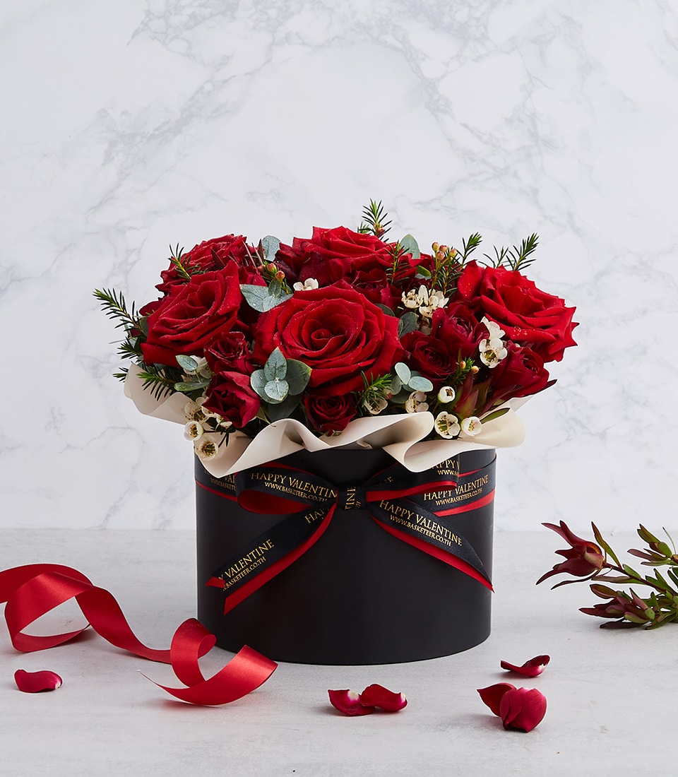 Luxurious red roses with eucalyptus in black hatbox, Valentine's Day gift arrangement