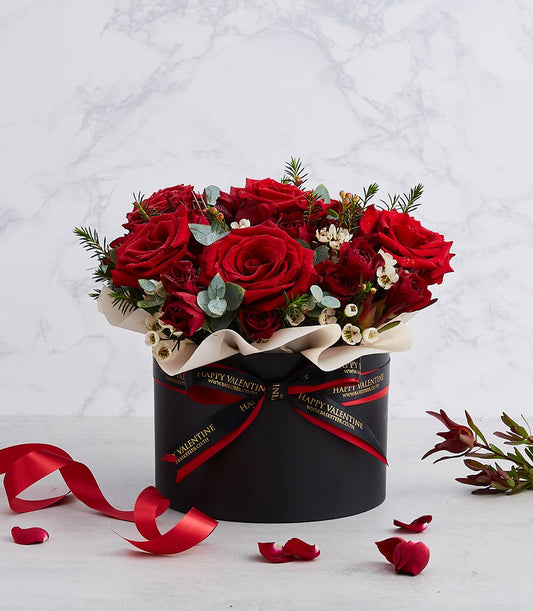 Luxurious red roses with eucalyptus in black hatbox, Valentine's Day gift arrangement