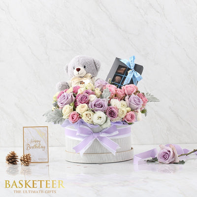 Luxury grey hatbox gift with lavender roses, teddy bear, and chocolates for birthday celebration