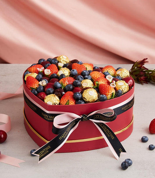 Heart-shaped luxury gift box with fresh strawberries, blueberries, cherries and Ferrero Rocher chocolates, Valentine's Day
