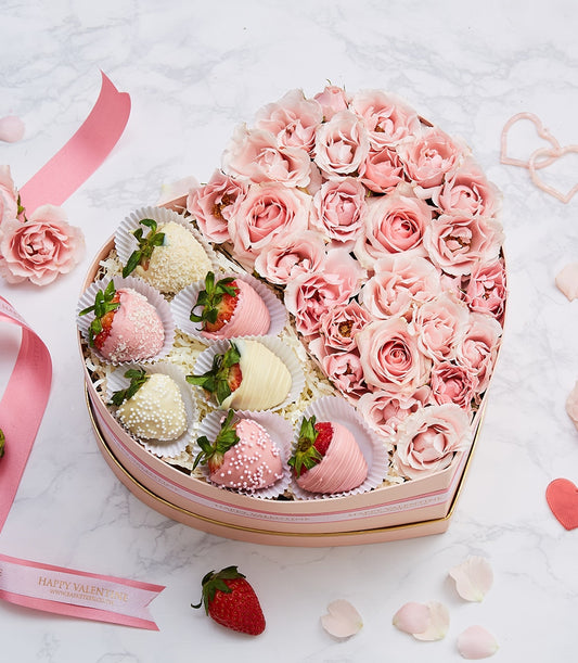 Heart-shaped gift box with pink roses and chocolate-covered strawberries, gold-trimmed anniversary gift
