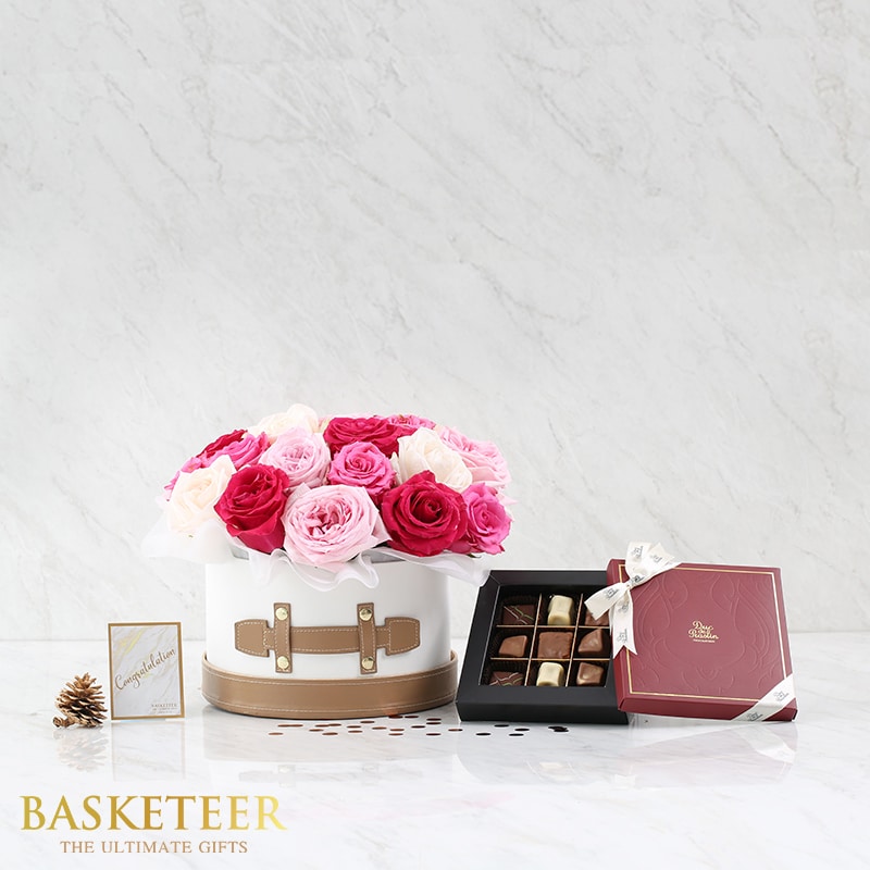 Premium rose flower box with pink and cream blooms paired with artisan chocolates, elegant gift set on marble