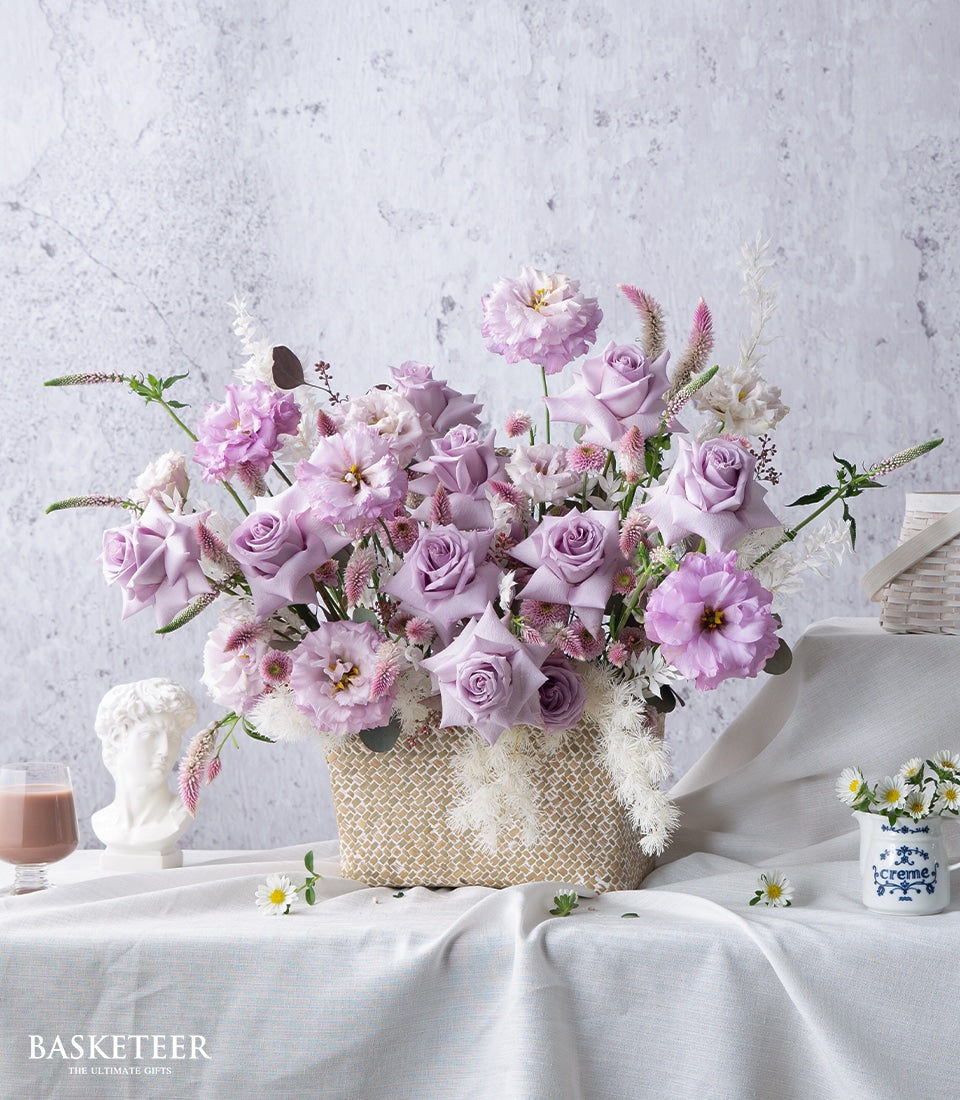 Purple and lavender rose arrangement in woven basket with lisianthus, get well gift with fresh flowers