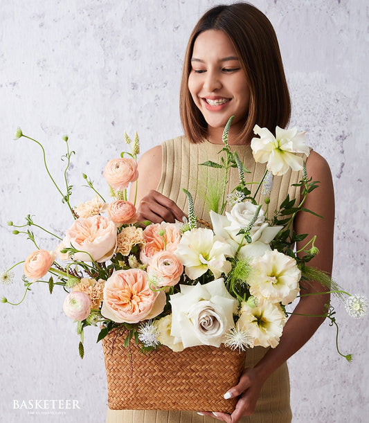 Premium David Austin roses and ranunculus in woven basket, peach and cream flowers for get well wishes
