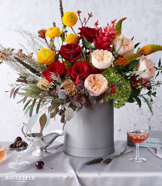 English Juliet David Austin roses with ranunculus and garden roses in light grey luxury hatbox