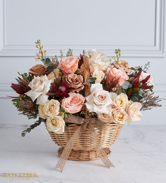 Timeless Elegance rose basket with peach, pink, and cream roses in woven wicker with ribbon bow
