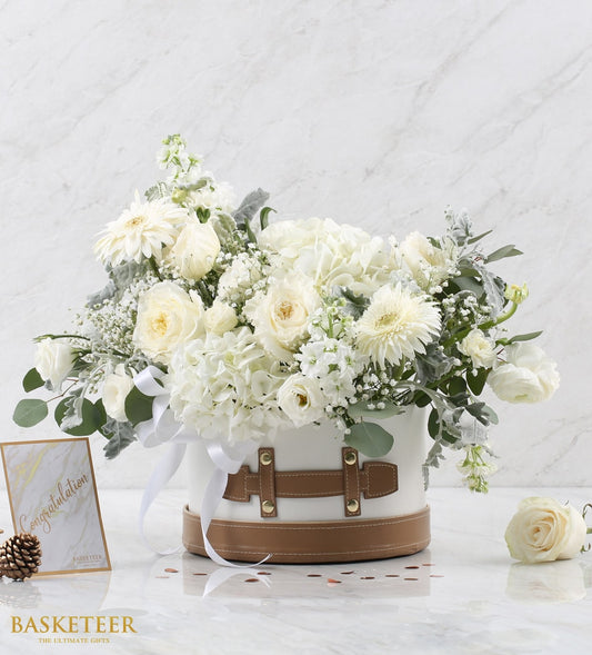 White roses and hydrangeas in luxury hatbox with satin ribbon, get well flowers arrangement