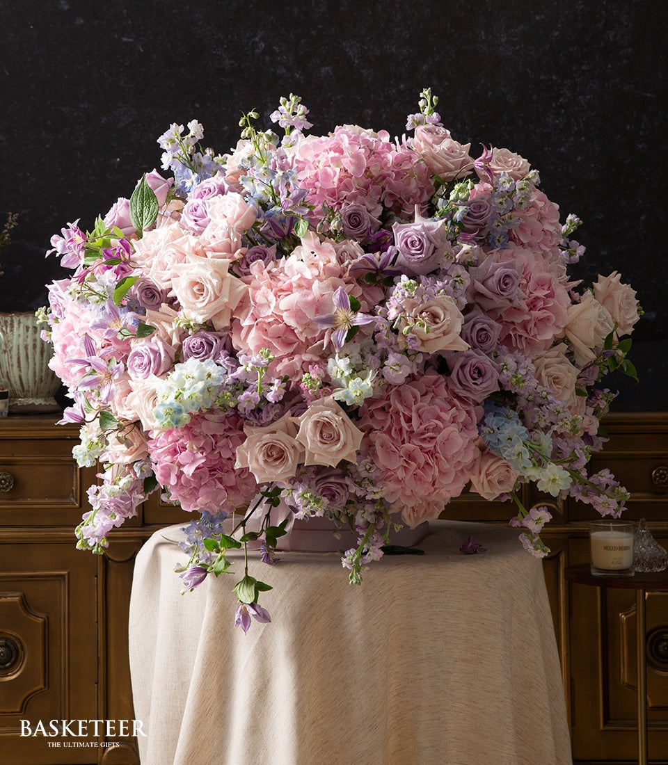 Luxury blush and lavender rose arrangement with pink hydrangeas in premium gift box