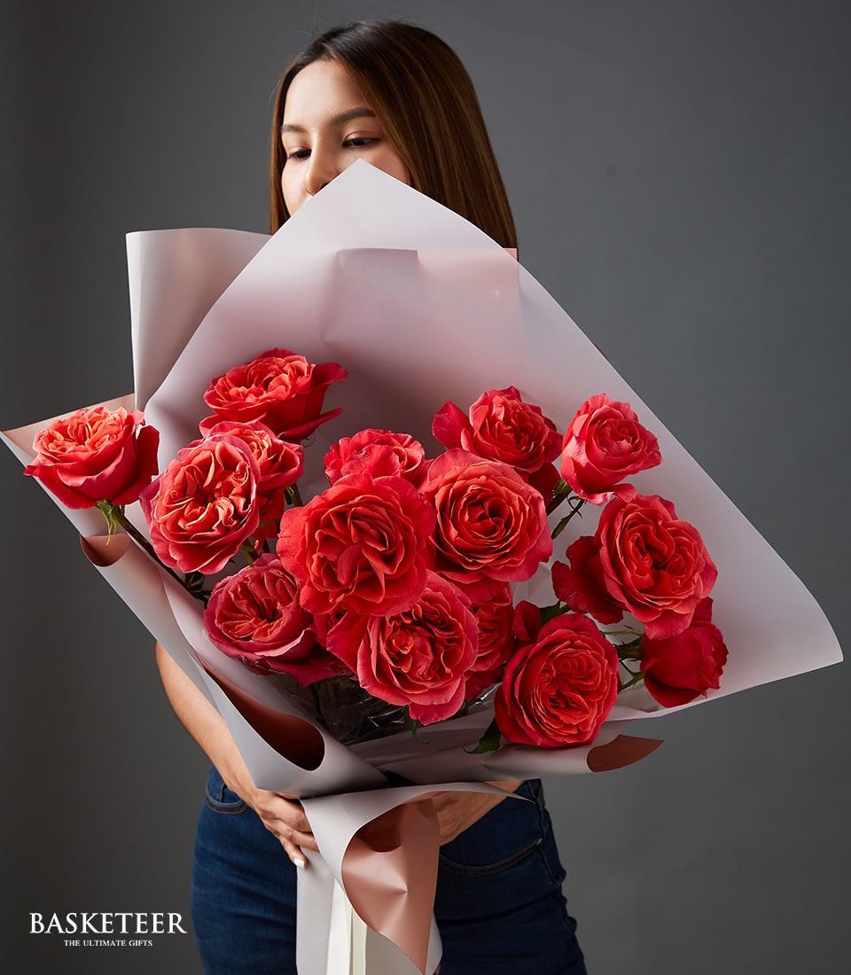Vibrant red and orange rose bouquet with rose gold ribbon, perfect Valentine's gift for her