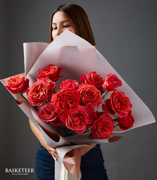 Vibrant red and orange rose bouquet with rose gold ribbon, perfect Valentine's gift for her