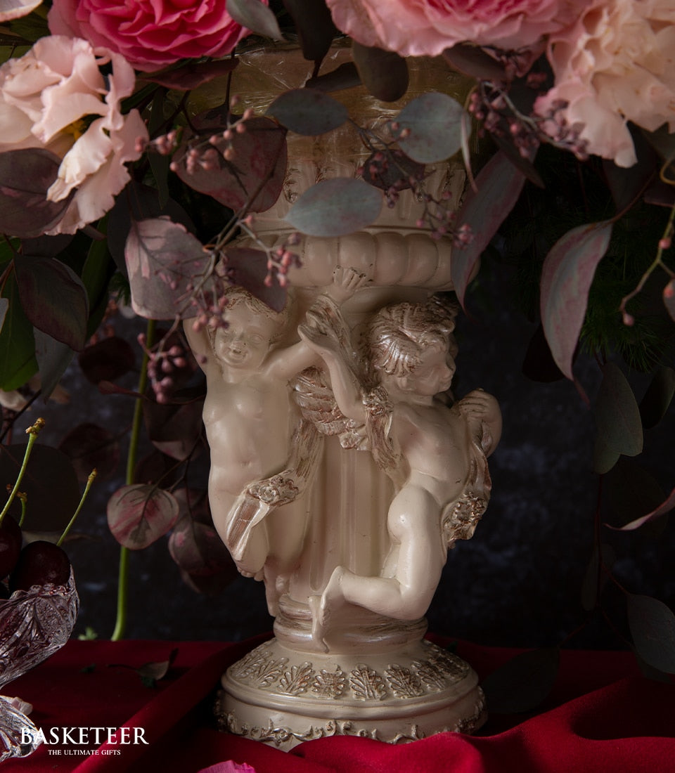 Cream classical vase with cherub details filled with pink roses and eucalyptus, luxury floral arrangement for gifting