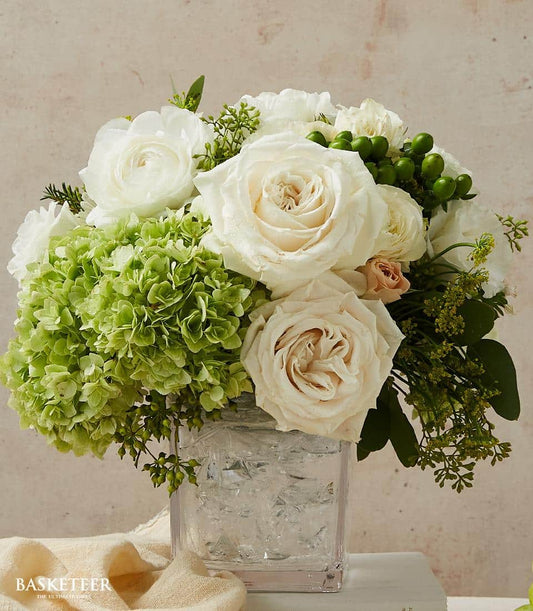 Serene white and cream roses with green hydrangeas in clear square glass vase, fresh flowers for gifting
