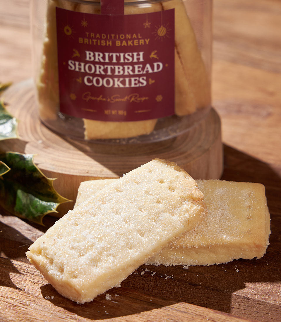 Traditional British shortbread cookies in festive gift container with holly decoration