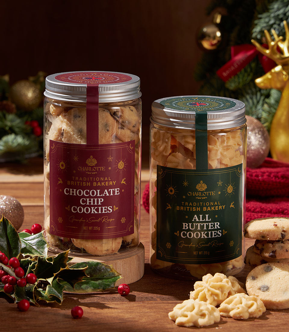Charlotte Bakery chocolate chip and butter cookies in festive gift jars with gold-accented labels, Christmas setting