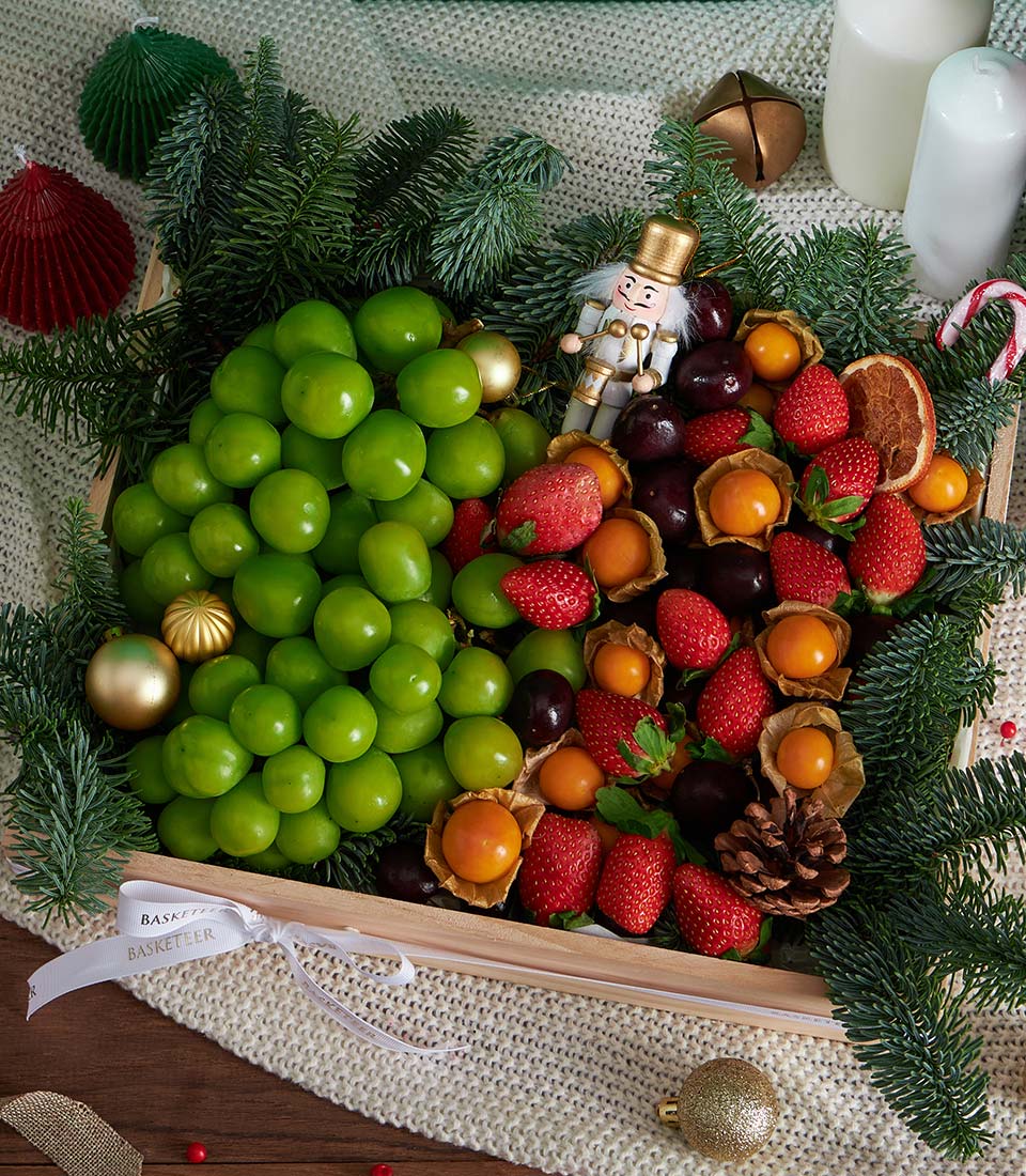 Premium festive fruit gift box with Shine Muscat, strawberries, and cherries in wooden tray with gold and red Christmas