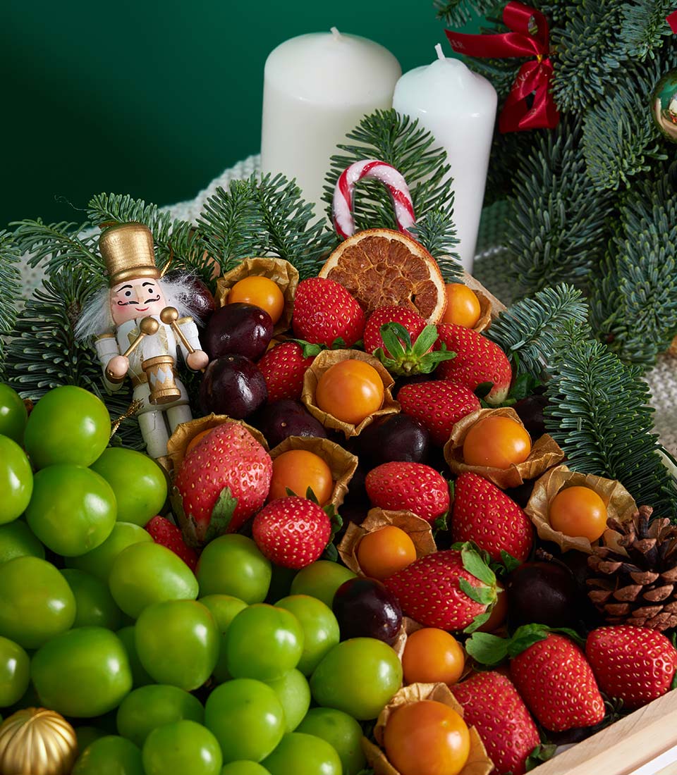 Premium festive fruit gift box with Shine Muscat grapes, fresh strawberries, cherries, and physalis nestled with pine