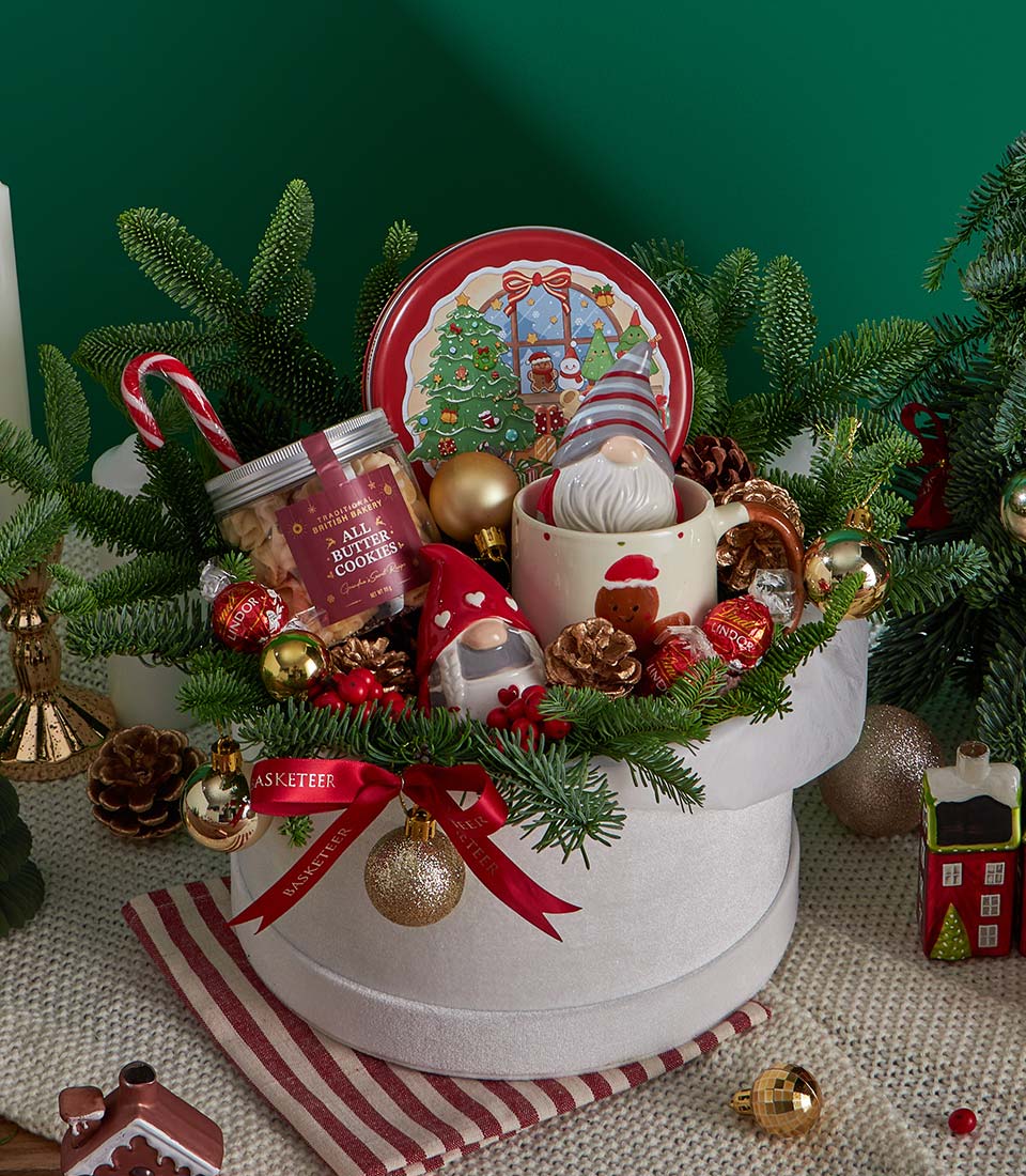 Festive Christmas gift basket with butter cookies, Lindor chocolates, and holiday decorations in white velvet box