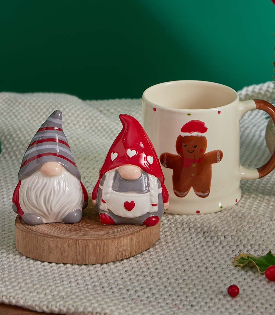Festive ceramic gnomes and gingerbread mug Christmas gift basket with holiday decorations