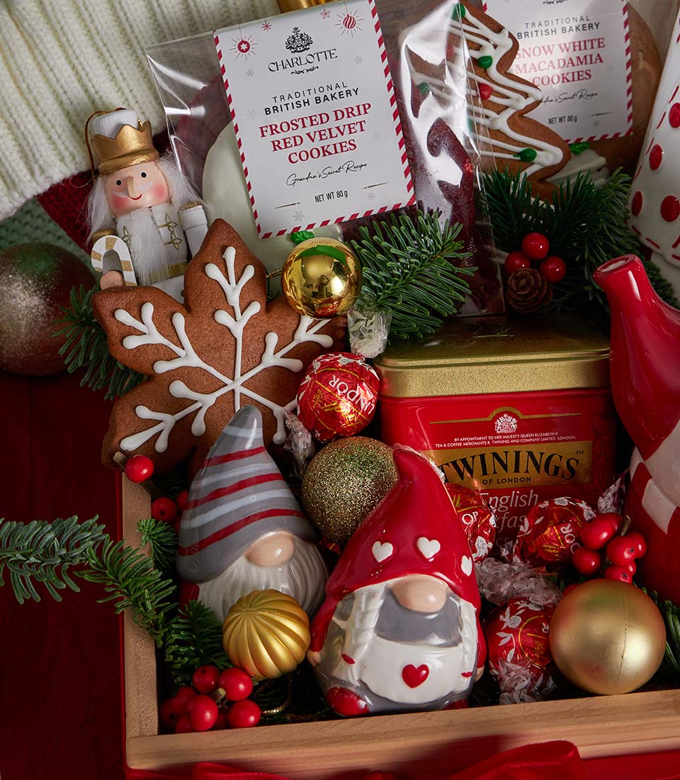 Luxury Christmas tea, cookies and chocolate gift set in wooden crate with festive ornaments and gingerbread
