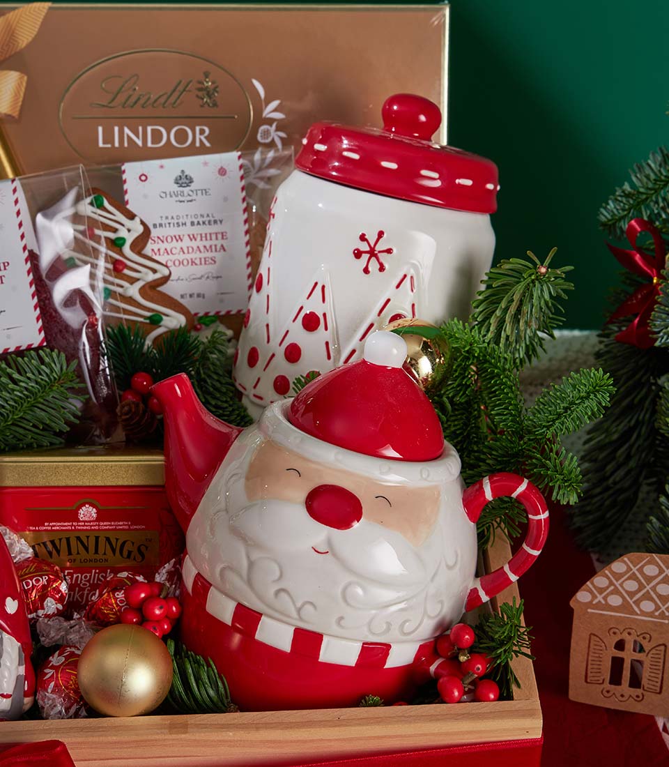Luxury Christmas tea, cookies and chocolate gift set with ceramic Santa teapot and festive treats in wooden tray