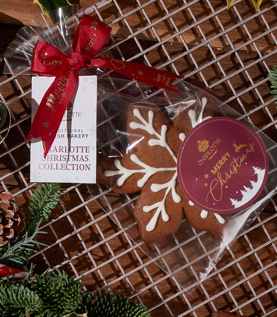 Charlotte Bakery gingerbread cookies, snowflake-shaped with icing. A festive artisan pastry gift for birthday cake delivery in Bangkok.