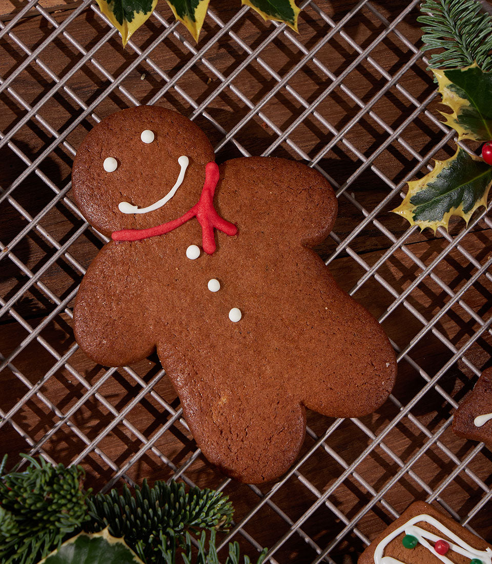 Artisan gingerbread man from Charlotte Bakery, decorated with icing and seasonal foliage. A British bakery treat for Bangkok.