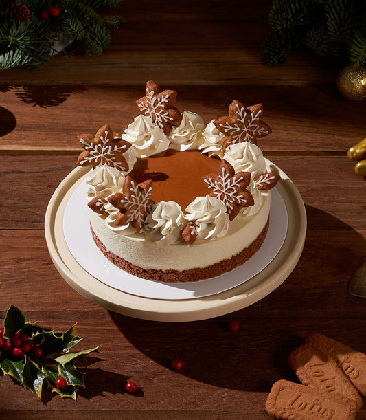 Gingerbread Biscoff Christmas cheesecake with caramel top and snowflake cookie decorations
