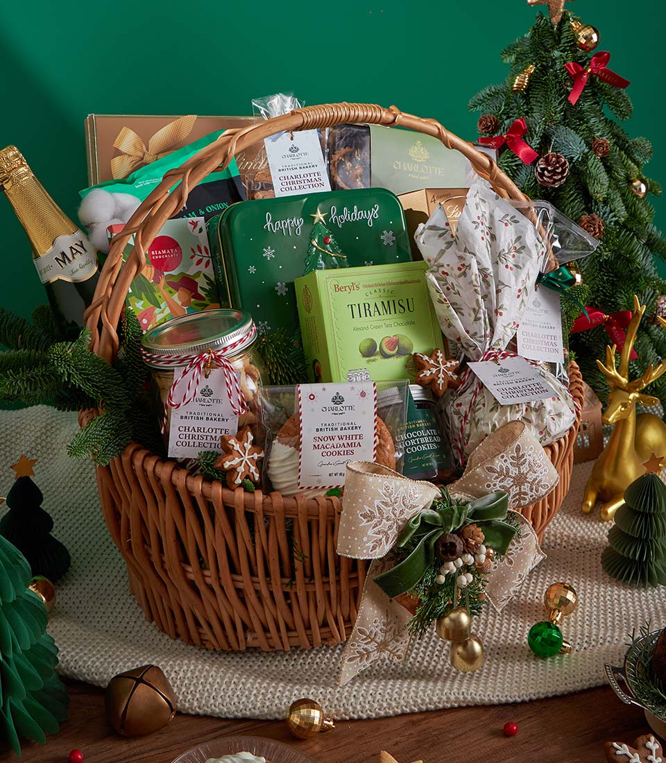 Luxury Christmas gourmet gift basket with sparkling wine, artisan chocolates, British bakery treats, and festive ribbon in