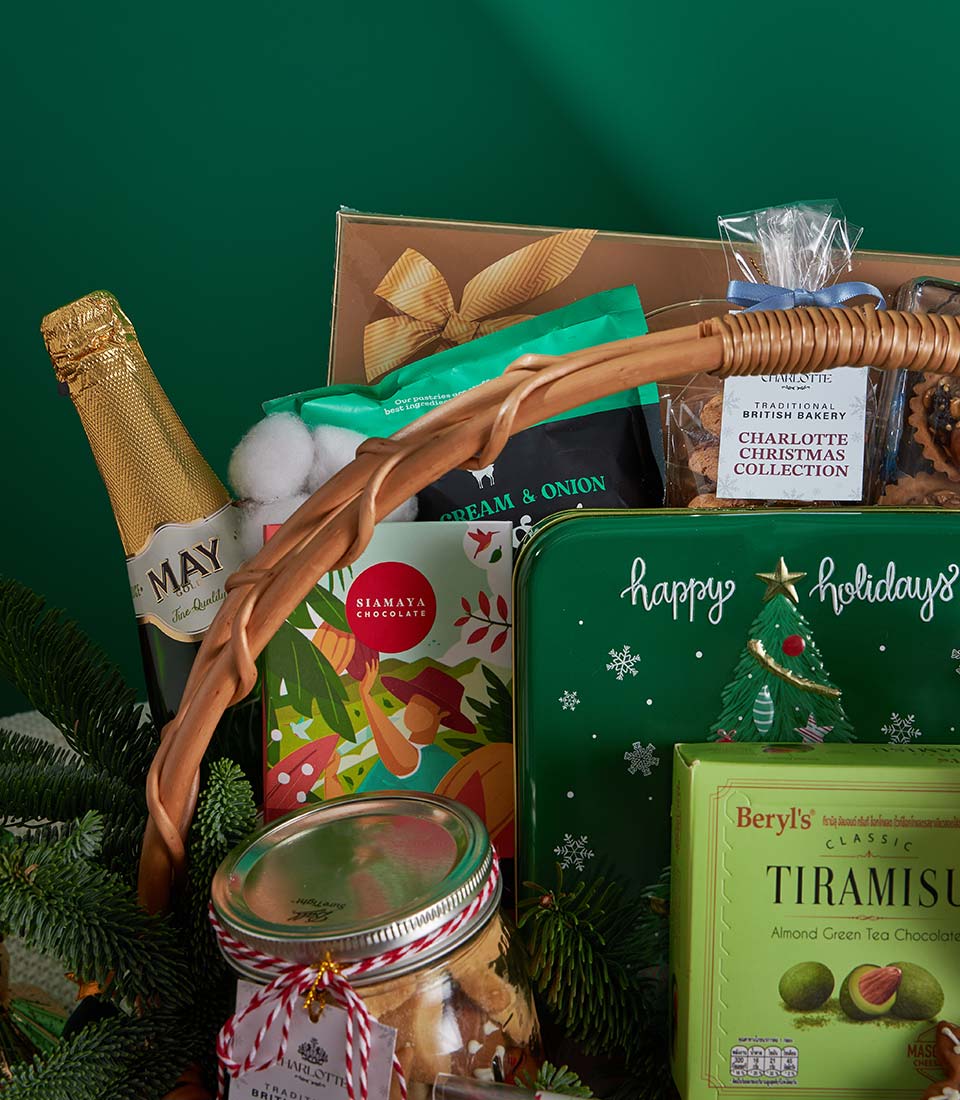 Emerald luxury Christmas gift basket with champagne, artisan chocolates, gourmet treats, and festive pine accents