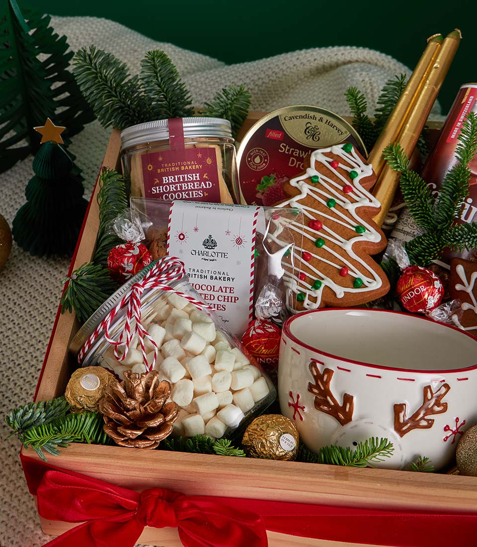 Festive Christmas cookie and chocolate gift box with British shortbread, gingerbread tree, and gold truffles in wooden crate