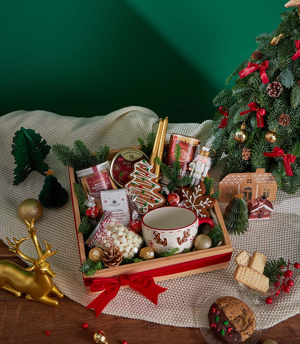Festive Christmas gift box with British shortbread cookies, reindeer mug, marshmallows, gingerbread, and gold chocolates