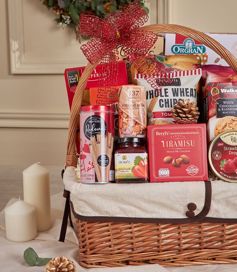 Premium red and gold snack gift basket with chocolate wafers, cookies, and gourmet treats for New Year celebrations