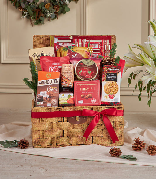 Luxury red ribbon woven gift basket filled with gourmet chocolates, brownies, jam, and artisan treats for New Year gifting