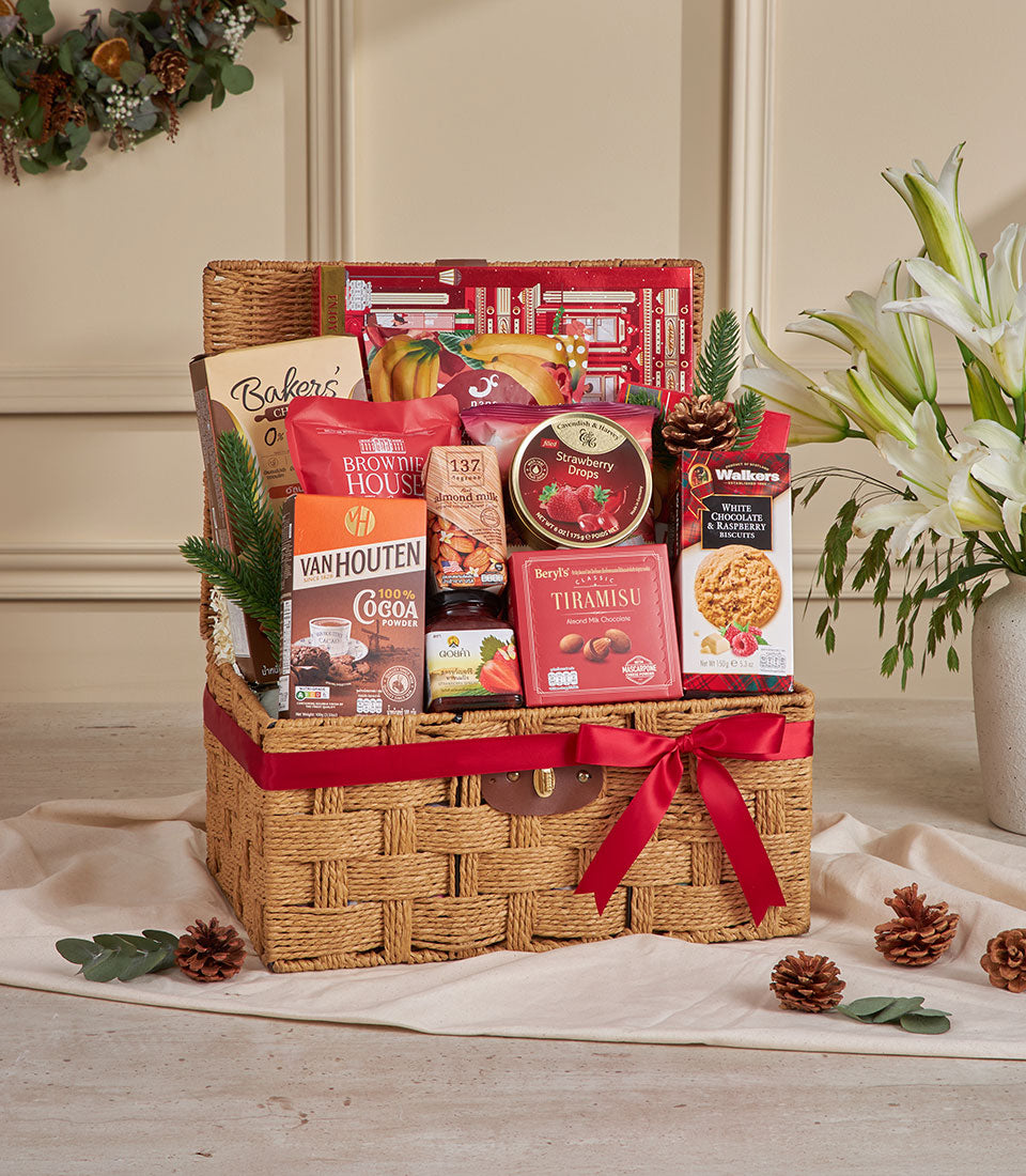 Premium red wicker gift basket filled with gourmet snacks, cocoa, chocolates and biscuits for New Year gifting