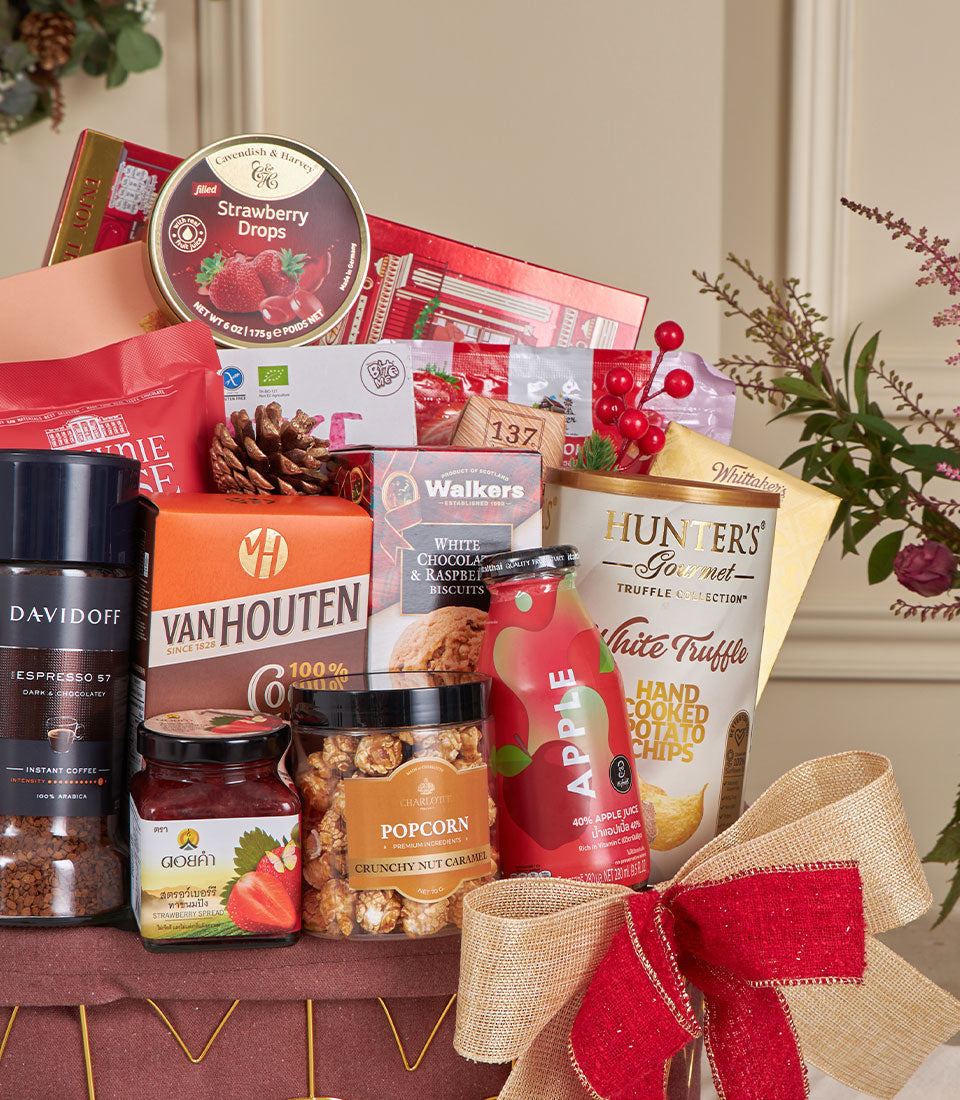 Deluxe red gourmet snack basket with strawberry drops, white chocolate biscuits, caramel popcorn, and coffee for New Year