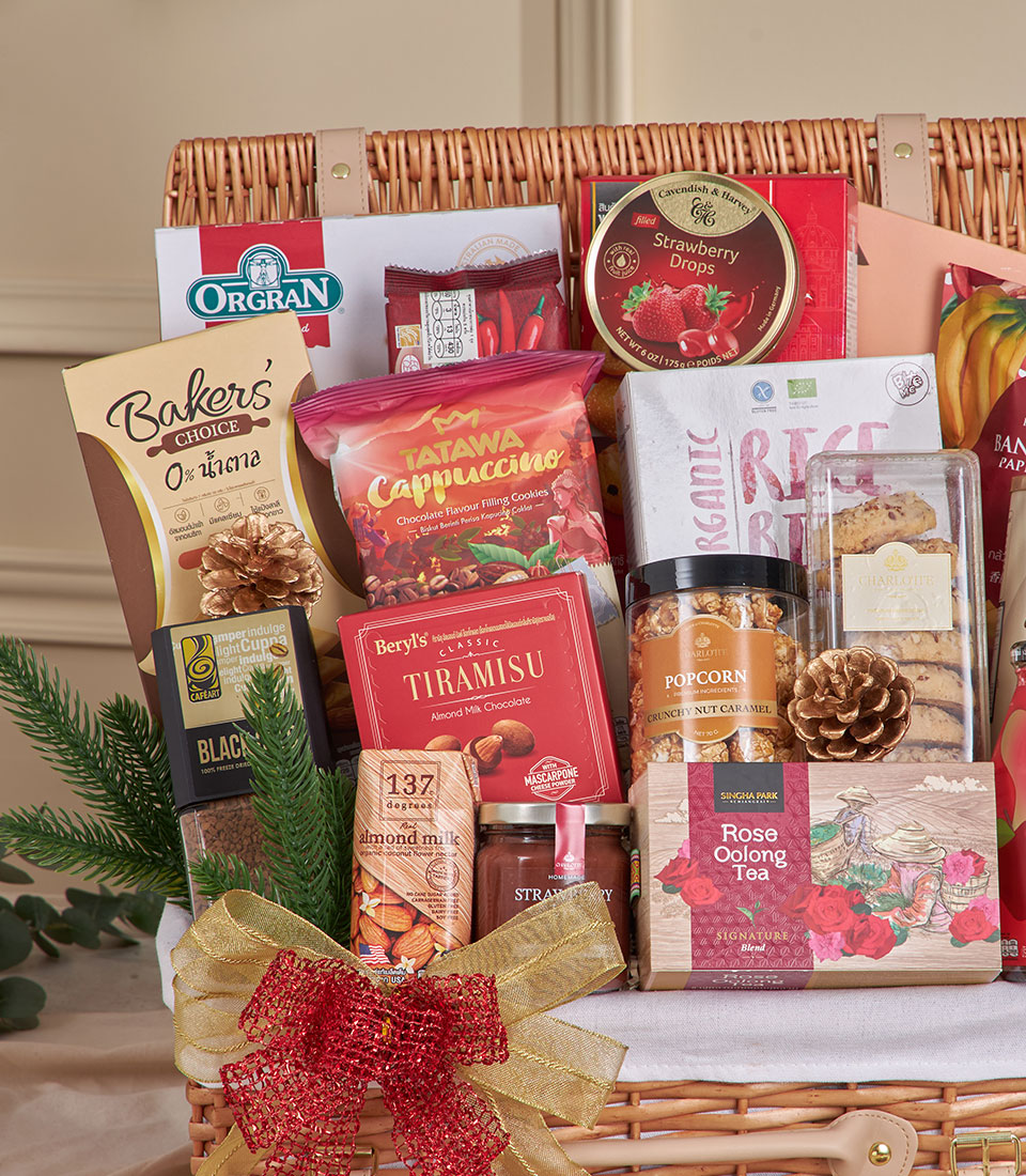 Premium wicker hamper with gourmet coffee, chocolates, and gourmet snacks tied with gold ribbon for New Year gifting