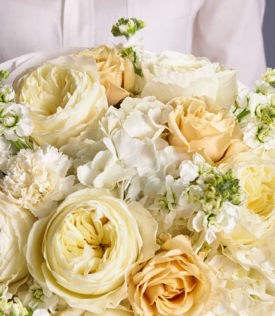 Ivory garden rose and hydrangea bouquet with peach roses and white carnations