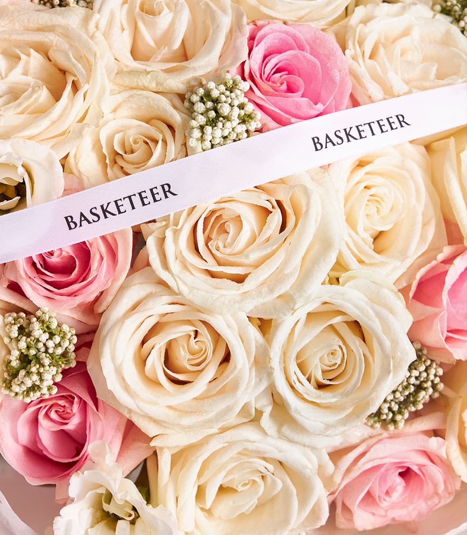 Premium mixed rose bouquet in cream, peach, and pink with white filler flowers, elegant gift arrangement