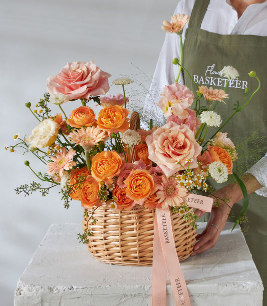Sunset Glow peach and orange rose flower basket with gerbera daisies, perfect for birthday gifts