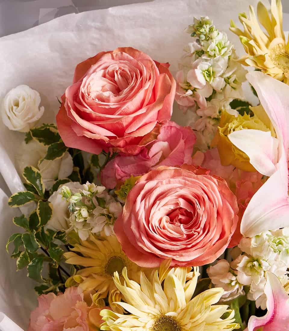Pink lilies and peach roses champagne bouquet with white ranunculus and gerbera daisies for anniversary