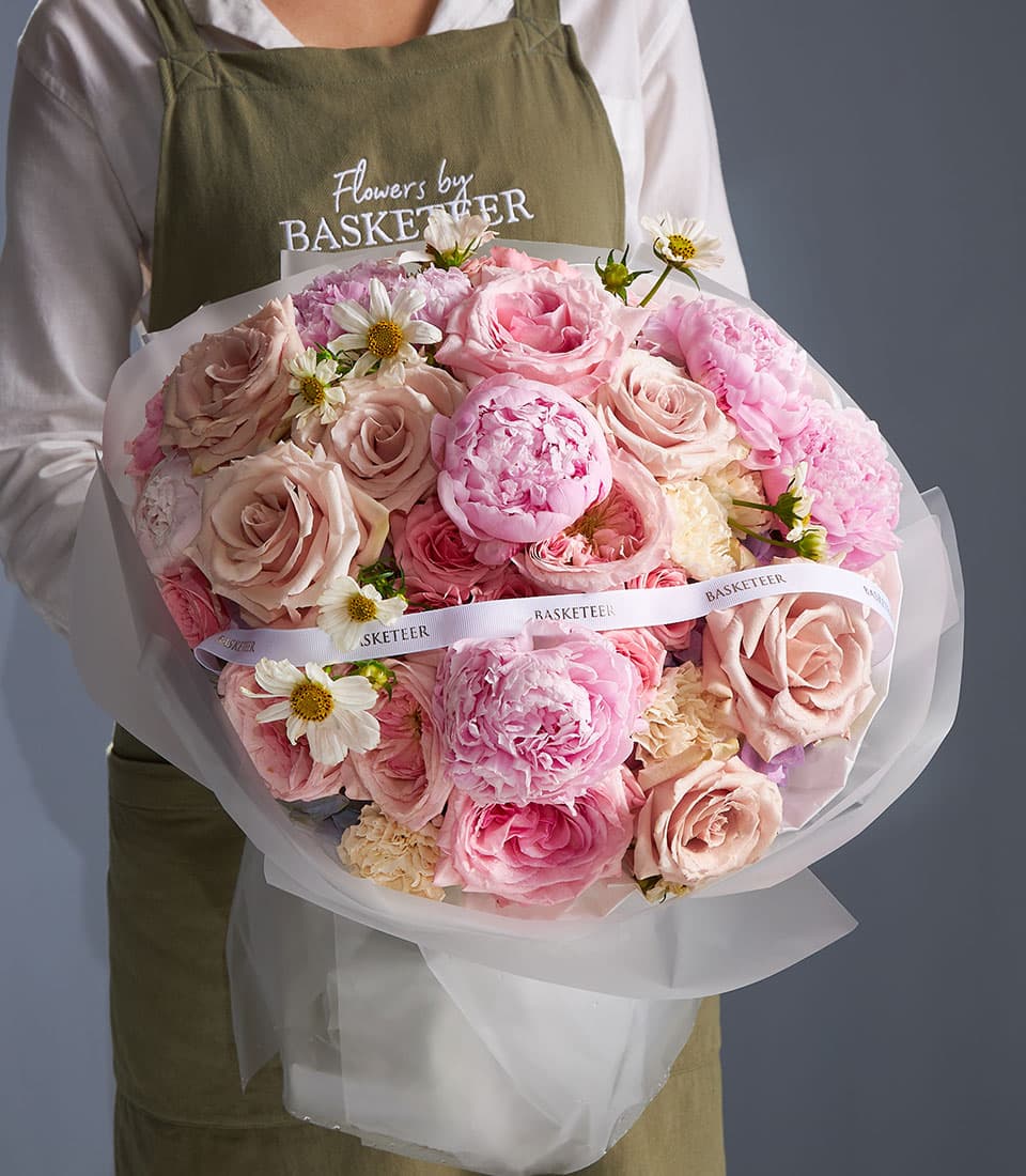 Blush peony and rose bouquet with cream daisies, wrapped in white paper with white ribbon