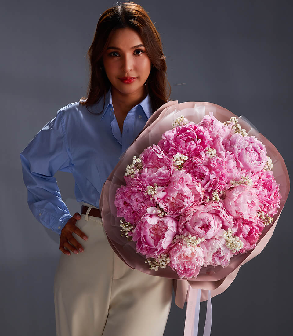 Luxury pink peony bouquet with white filler flowers, wrapped in blush paper and ribbon